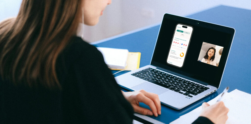 A woman carrying out a video call on her laptop discussing academic digital health app development