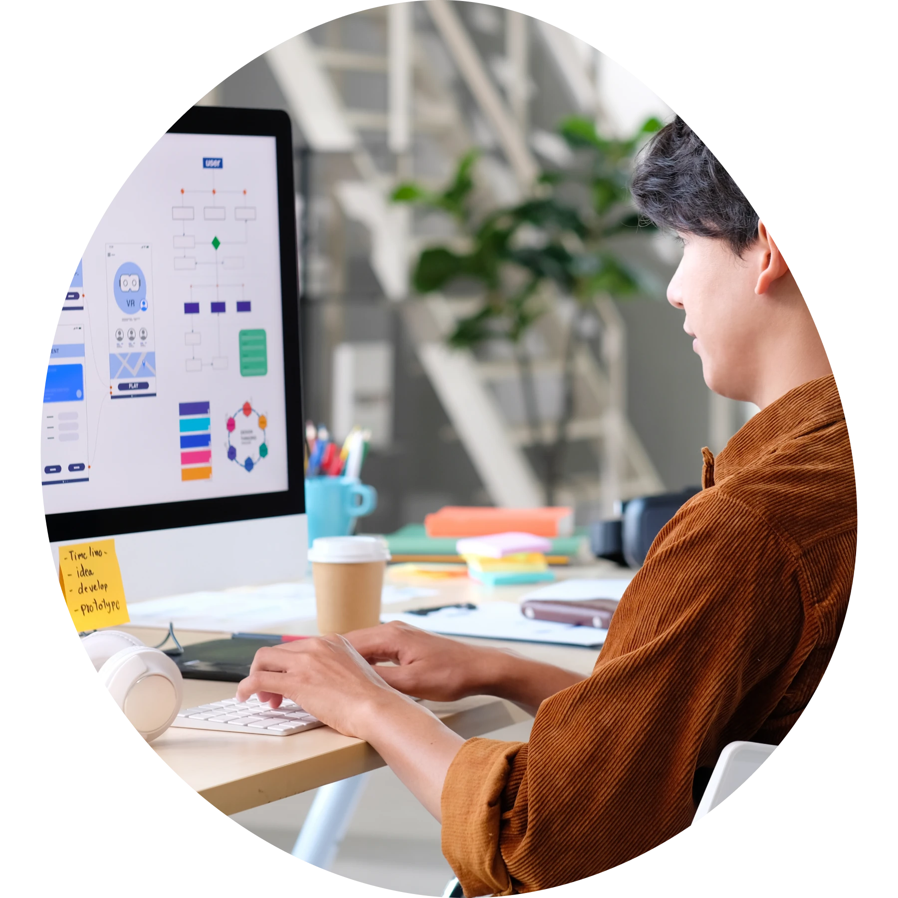 Man working on a visual design application on a desktop computer.