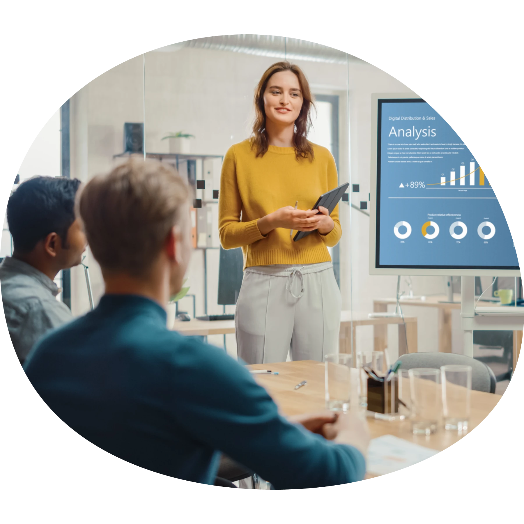 Woman standing in front a tv doing a presentation.